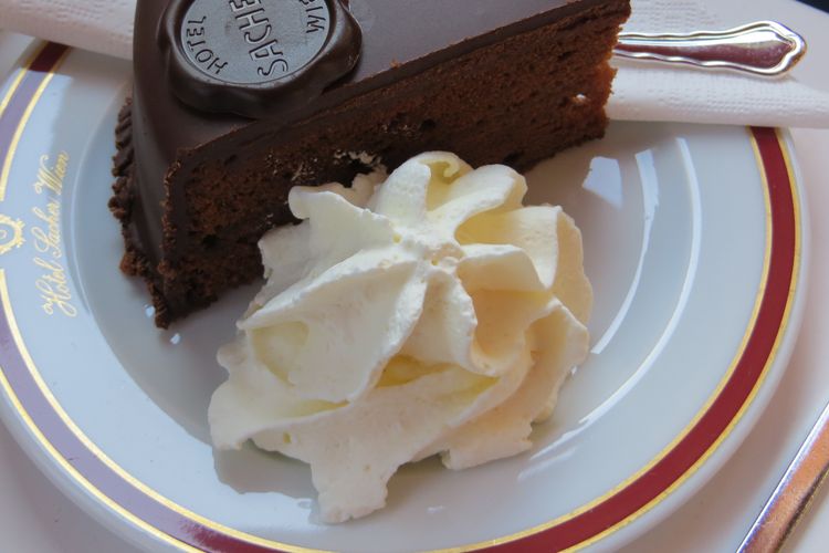 no visit to vienna would be complete without a stop in a historic coffee house eating a slice of sacher torte with whipped cream