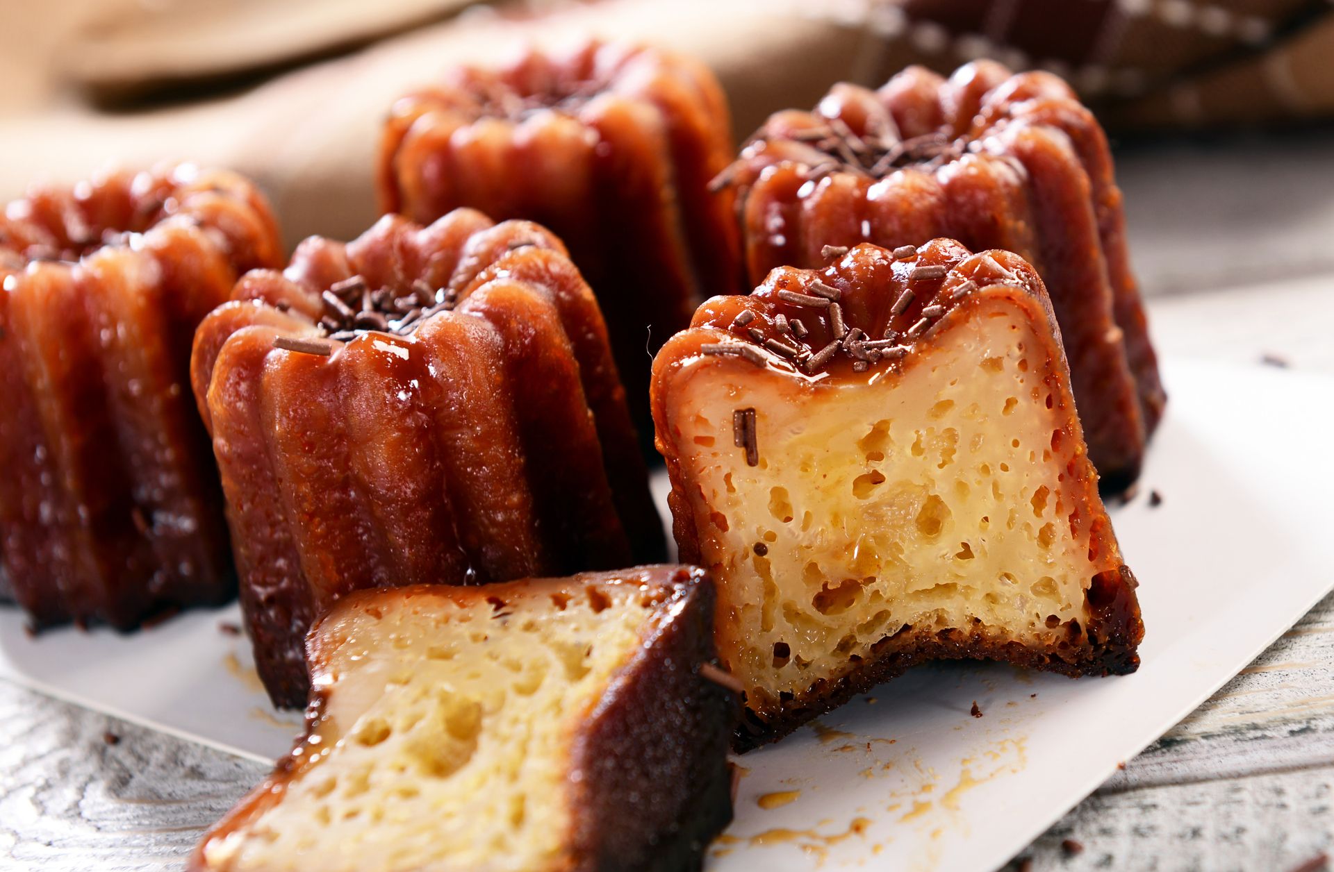Caneles: small French pastry flavored with rum and vanilla with a soft and tender custard center and a dark, thick caramelized crust. 