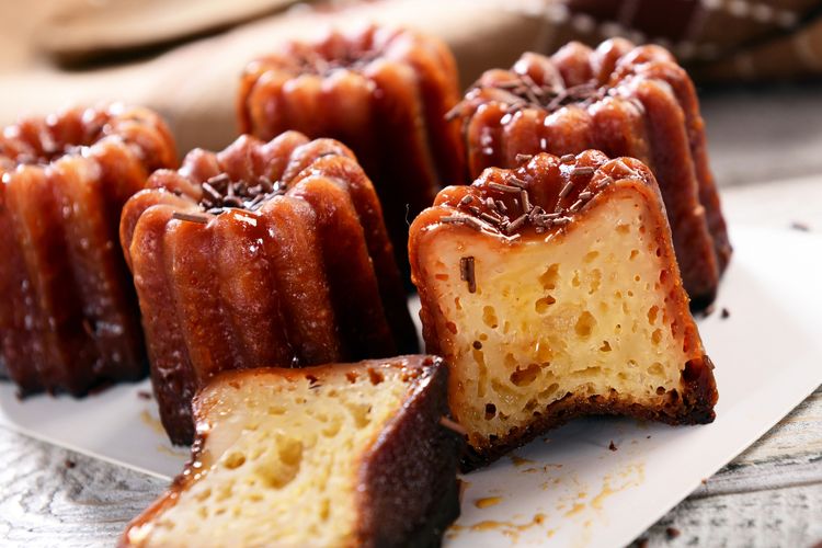 Caneles: small French pastry flavored with rum and vanilla with a soft and tender custard center and a dark, thick caramelized crust. 